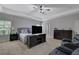 Spacious main bedroom features tray ceiling, ceiling fan, and carpet flooring at 4251 Haywater Cv, Buford, GA 30519