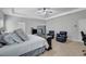 Spacious main bedroom features tray ceiling, ceiling fan, and carpet flooring at 4251 Haywater Cv, Buford, GA 30519
