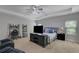 Spacious main bedroom features tray ceiling, ceiling fan, and carpet flooring at 4251 Haywater Cv, Buford, GA 30519