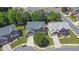 Aerial view of homes with manicured lawns in a well-planned neighborhood with tree-lined streets at 590 Kyle Trace Ct, Sugar Hill, GA 30518
