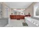 A luxurious bathroom with separate shower, garden tub, and dual sinks at 590 Kyle Trace Ct, Sugar Hill, GA 30518