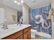 Bright bathroom with a double sink vanity and a unique octopus-themed shower curtain at 590 Kyle Trace Ct, Sugar Hill, GA 30518