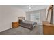 Bedroom featuring a queen bed, ceiling fan, and natural light at 590 Kyle Trace Ct, Sugar Hill, GA 30518