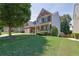 Charming home with manicured lawn, lush trees, and a welcoming entrance at 590 Kyle Trace Ct, Sugar Hill, GA 30518