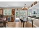 Eat-in kitchen featuring granite countertops, stainless steel appliances, and access to an outdoor deck at 590 Kyle Trace Ct, Sugar Hill, GA 30518