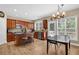 Kitchen with stainless steel appliances, wooden cabinets, and an adjacent dining area at 590 Kyle Trace Ct, Sugar Hill, GA 30518