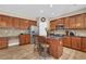 Well-equipped kitchen with wooden cabinets, granite countertops, and stainless steel appliances at 590 Kyle Trace Ct, Sugar Hill, GA 30518