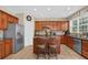 Kitchen includes stainless steel appliances, a kitchen island, and wood cabinets at 590 Kyle Trace Ct, Sugar Hill, GA 30518