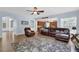 Open living room showcasing a plush sectional sofa and seamless flow to the adjacent kitchen at 590 Kyle Trace Ct, Sugar Hill, GA 30518