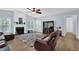 Inviting living room with a ceiling fan and a cozy recliner, perfect for relaxation at 590 Kyle Trace Ct, Sugar Hill, GA 30518