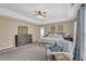 Spacious main bedroom with tray ceiling, sitting area, ensuite bathroom, and neutral décor at 590 Kyle Trace Ct, Sugar Hill, GA 30518