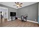 Home office with hardwood floors, a ceiling fan, and natural light, perfect for remote work at 590 Kyle Trace Ct, Sugar Hill, GA 30518