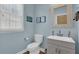 Stylish powder room featuring a modern vanity, sleek fixtures, and neutral color palette at 590 Kyle Trace Ct, Sugar Hill, GA 30518