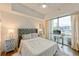 Sunlit bedroom featuring large window, platform bed, and charming turquoise nightstand with modern decor at 1100 Howell Mill Nw Rd # 312, Atlanta, GA 30318