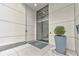 Modern building entrance featuring glass doors, planters, and clean architectural lines at 1100 Howell Mill Nw Rd # 312, Atlanta, GA 30318