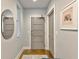 Modern entryway with gray door, hardwood floors and mirror at 1100 Howell Mill Nw Rd # 312, Atlanta, GA 30318