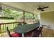 Covered porch with ceiling fan and outdoor seating overlooks fenced backyard at 1404 Vernon North Dr, Dunwoody, GA 30338