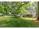 Green backyard with a deck, mature trees, and a well-maintained lawn at 1404 Vernon North Dr, Dunwoody, GA 30338