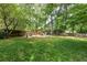 Spacious backyard with mature trees and playground area at 1404 Vernon North Dr, Dunwoody, GA 30338