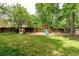Spacious backyard with mature trees and playground area at 1404 Vernon North Dr, Dunwoody, GA 30338