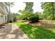 Expansive backyard with lush grass, a wooden playset, patio, and mature trees surrounding the property at 1404 Vernon North Dr, Dunwoody, GA 30338