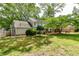 Spacious backyard featuring mature trees, a fence, and lush greenery at 1404 Vernon North Dr, Dunwoody, GA 30338