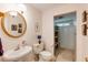 Cozy bathroom featuring a pedestal sink, gold mirror, with a tiled shower at 1404 Vernon North Dr, Dunwoody, GA 30338