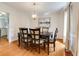 Classic dining room featuring a wooden table, six chairs, modern lighting, and a neutral color palette at 1404 Vernon North Dr, Dunwoody, GA 30338
