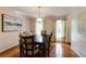 Bright dining room with wood floors, a wooden table, and natural light from the windows at 1404 Vernon North Dr, Dunwoody, GA 30338