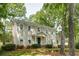 Charming two-story traditional home with a manicured lawn and mature trees providing shade at 1404 Vernon North Dr, Dunwoody, GA 30338