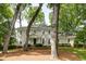 Charming two-story traditional home with a manicured lawn and mature trees providing shade at 1404 Vernon North Dr, Dunwoody, GA 30338