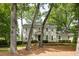 Charming two-story traditional home with a manicured lawn and mature trees providing shade at 1404 Vernon North Dr, Dunwoody, GA 30338