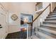 Inviting foyer with slate flooring, staircase, and view to the living spaces at 1404 Vernon North Dr, Dunwoody, GA 30338