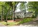 Charming two-story traditional home with a manicured lawn, mature trees, and a long driveway at 1404 Vernon North Dr, Dunwoody, GA 30338