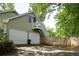 Two-car garage with apartment above and a white wooden fence at 1404 Vernon North Dr, Dunwoody, GA 30338