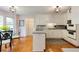Charming eat-in kitchen with white cabinets, an island, stainless steel appliances, and hardwood floors at 1404 Vernon North Dr, Dunwoody, GA 30338
