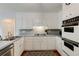 Traditional kitchen with white cabinets, stainless appliances, and hardwood floors at 1404 Vernon North Dr, Dunwoody, GA 30338