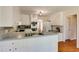 Well-lit kitchen featuring white cabinets, stainless steel appliances, and ample counter space at 1404 Vernon North Dr, Dunwoody, GA 30338