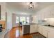 Bright kitchen with stainless appliances, hardwood floors and a cozy breakfast nook by large windows at 1404 Vernon North Dr, Dunwoody, GA 30338