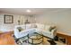 Comfortable living room with a white couch, a glass table, and a patterned rug over hardwood floors at 1404 Vernon North Dr, Dunwoody, GA 30338