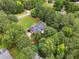 Aerial view of a beautiful red home in a wooded area with a large lawn at 239 Berry Rd, Mcdonough, GA 30252