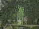 Property line as seen from above. Mature trees surrounding a two story house at 239 Berry Rd, Mcdonough, GA 30252