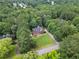 Secluded home among mature trees, featuring a long driveway and expansive lawn at 239 Berry Rd, Mcdonough, GA 30252