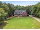 Beautiful home nestled amongst mature trees and lush greenery at 239 Berry Rd, Mcdonough, GA 30252