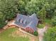 Stunning aerial view of a red home with a well-manicured lawn and mature trees at 239 Berry Rd, Mcdonough, GA 30252