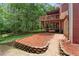 Multi-level backyard featuring a deck, patio space, a retaining wall and access to the garage at 239 Berry Rd, Mcdonough, GA 30252
