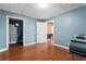 Basement area featuring laminated wood flooring and a door to a storage area at 239 Berry Rd, Mcdonough, GA 30252