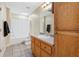 Bright bathroom with a single sink vanity, skylight, and shower tub combo at 239 Berry Rd, Mcdonough, GA 30252
