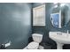 Cozy half bathroom featuring a pedestal sink, toilet, and a window for natural light at 239 Berry Rd, Mcdonough, GA 30252