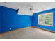Bright bedroom with a ceiling fan and a large window providing natural light at 239 Berry Rd, Mcdonough, GA 30252